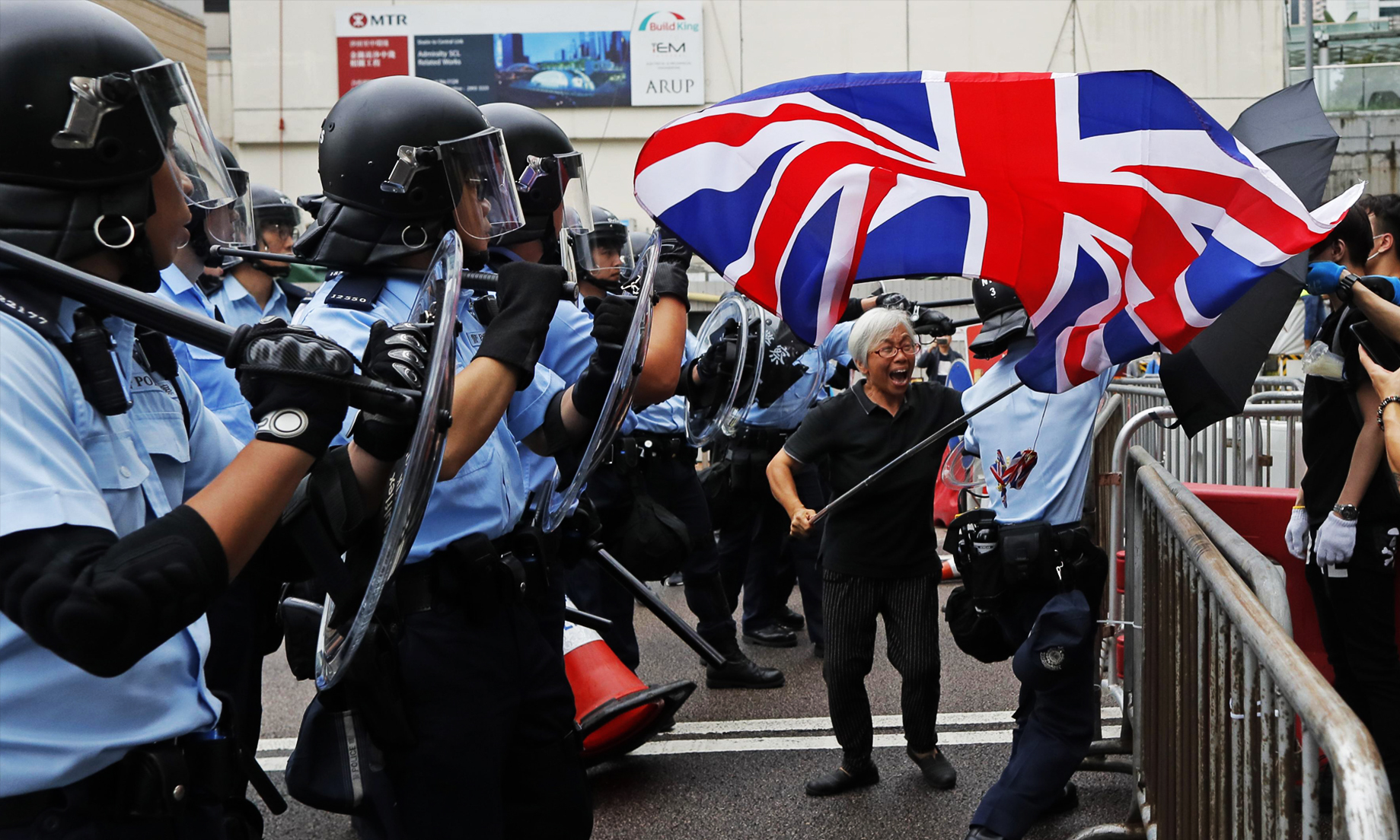 Hong Kong riot police clash with protesters at airport