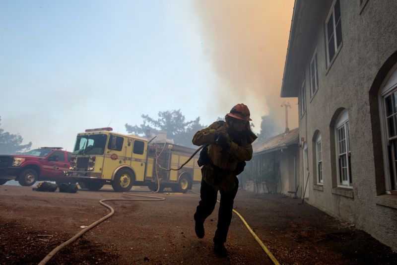 California firefighters race to subdue flames before heat and winds return