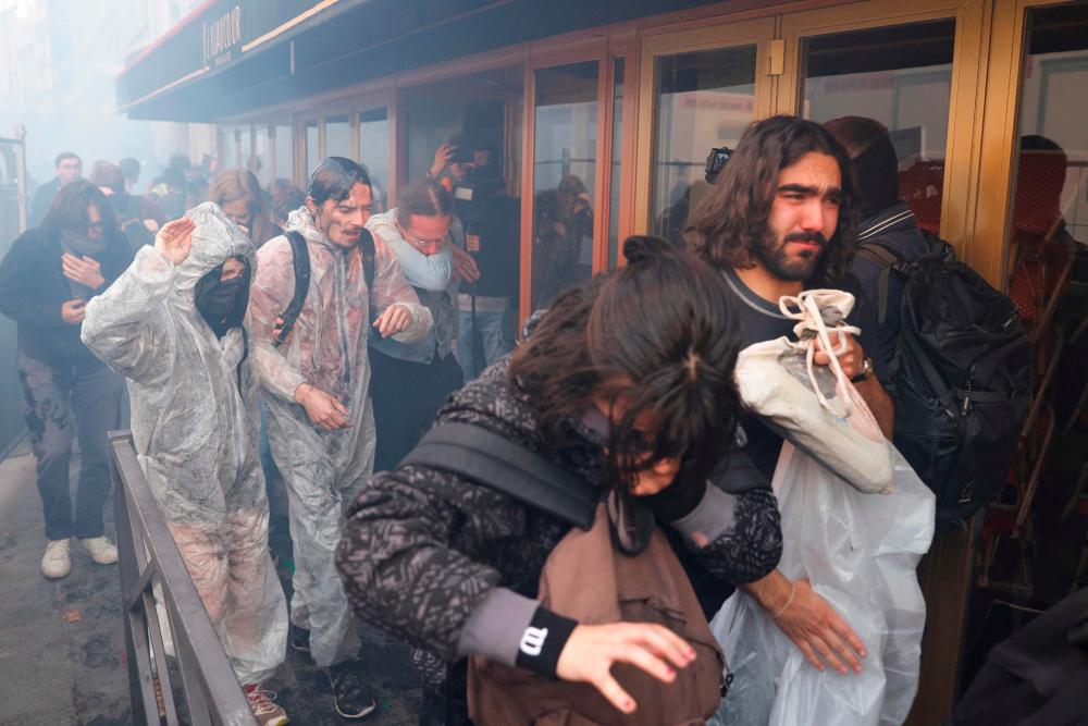 French police teargas protesters at oil giant’s meeting