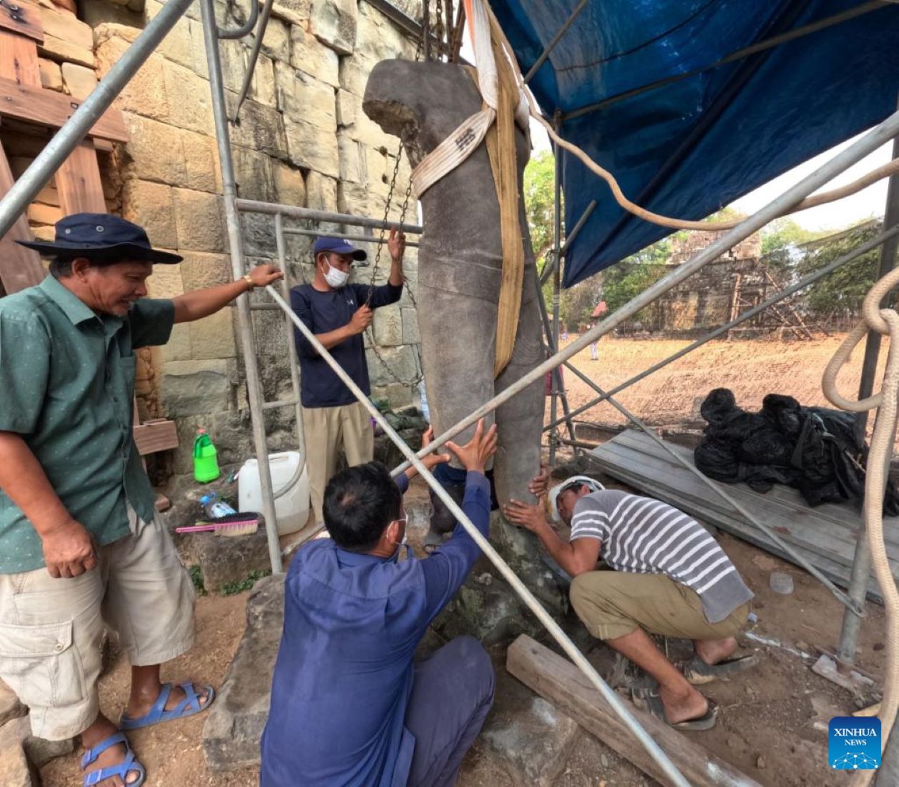 Ancient Statue In Restoration At Phnom Bakheng Temple In Cambodia’s Angkor